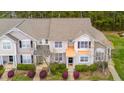 Aerial view of townhome with well-manicured landscaping, gray roof, and covered entry at 4114 Brenmar Ln, Durham, NC 27713