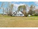 View of the house with a welcoming front porch and a large, open front yard at 44 Loop Rd, Archer Lodge, NC 27527