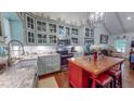 Charming kitchen boasts custom cabinetry, stainless steel appliances, a center island, and granite counters at 468 Loftis Loop Rd, Roxboro, NC 27574