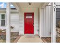 Close-up of the vibrant red front door featuring modern hardware and a covered porch at 503 N Sellers St, Selma, NC 27576
