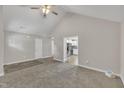 Open living room with access to the kitchen, neutral walls, vaulted ceiling and plush carpeting at 503 N Sellers St, Selma, NC 27576