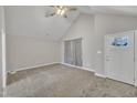 Spacious living room with neutral walls, plush carpeting, vaulted ceiling and ample natural light at 503 N Sellers St, Selma, NC 27576