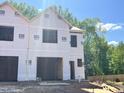New construction home featuring durable materials, an attached garage, and a modern design at 57 Calluna Dr, Clayton, NC 27520