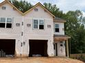 New construction featuring a two-story design, windows, and an attached garage, offering modern living at 57 Calluna Dr, Clayton, NC 27520