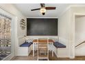 Cozy breakfast nook with wainscoting, built-in seating, and a chalkboard accent wall at 7708 Foxwood Dr, Raleigh, NC 27615
