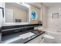 Bright bathroom with decorative window, modern fixtures, and tiled walls around the tub at 7825 Breckon Way, Raleigh, NC 27615