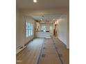 Bright, open-concept living space with hardwood flooring and modern light fixture at 801 N Elm St, Durham, NC 27701