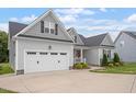 Lovely home with a two-car garage and a welcoming front porch, seamlessly blending comfort and style at 8925 Hopkins Knob Ct, Zebulon, NC 27597