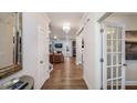 Inviting hallway with hardwood floors leading to a living room and kitchen with modern finishes at 937 Thimbleweed Way, Wake Forest, NC 27587