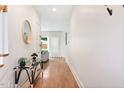 Bright hallway featuring wood floors, modern decor, and an open view into the adjacent living area at 1008 North St, Durham, NC 27701