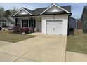 Traditional-style home showcasing a one-car garage and driveway at 11 Balboa Pkwy, Clayton, NC 27520