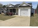 Traditional-style home showcasing a one-car garage and driveway at 11 Balboa Pkwy, Clayton, NC 27520