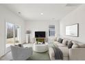 Cozy living room with comfortable seating, a modern television, and plenty of natural light at 112 Oat Grain Ct, Clayton, NC 27520