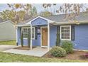 Charming blue home with a well-maintained lawn and manicured landscaping at 1120 N Roxboro St, Durham, NC 27701