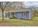 Charming blue home with a well-maintained lawn and manicured landscaping at 1120 N Roxboro St, Durham, NC 27701
