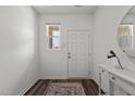 Inviting entryway features a console table, mirror, and a front door with a window at 1120 Tofino Dr, Durham, NC 27704