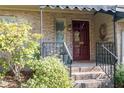Close-up of front entrance with brick steps, railing, and landscaped garden at 114 Montrose Dr # 114, Durham, NC 27707