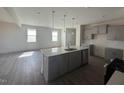 Open-concept kitchen with an island, stainless steel appliances, and an adjacent living area at 118 Fairwinds Drive Dr, Lillington, NC 27546
