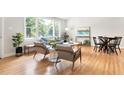 Well-lit living room with hardwood floors, comfortable seating, and large windows at 122 W Union St, Hillsborough, NC 27278