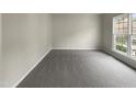 Spacious bedroom with a large window and plush gray carpet at 12316 Amoretto Way, Raleigh, NC 27613