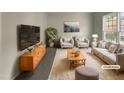 Bright living room with neutral tones, stylish furniture arrangement, and a large window providing plenty of natural light at 12316 Amoretto Way, Raleigh, NC 27613