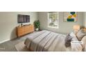 Bright bedroom features a large window, stylish furniture, and neutral decor for a cozy, modern feel at 12316 Amoretto Way, Raleigh, NC 27613