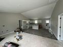 Bright, spacious kitchen with white cabinets and an island, offering ample storage and prep space at 129 Grace Pond Ave, Benson, NC 27504