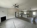 Open-concept living room and kitchen with a fireplace and hardwood floors at 129 Grace Pond Ave, Benson, NC 27504