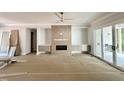 Spacious living room featuring a ceiling fan, fireplace, and sliding doors leading to the outdoor patio at 1309 Sanctuary Pond Dr, Raleigh, NC 27603