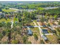 An aerial view of the property and the surrounding neighborhood with mature trees at 1406 Summerville Mamers Rd, Lillington, NC 27546