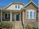 Stone accents, craftsman architecture, and a welcoming front porch highlight this beautiful home at 150 Lystra Ridge Rd, Chapel Hill, NC 27517