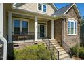 Charming front porch with stone accents and elegant railing, perfect for relaxation at 150 Lystra Ridge Rd, Chapel Hill, NC 27517