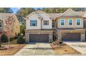 Beautiful townhome with a two-car garage, siding and brick exterior, and mature landscaping at 154 Alamosa Pl, Cary, NC 27519