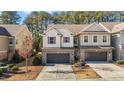 Inviting townhome featuring a brick and siding exterior, two-car garage, and a paved driveway at 154 Alamosa Pl, Cary, NC 27519
