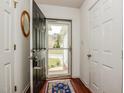 Entryway features a dark front door, wood floors, and convenient coat closet at 1808 W Cotton Gin Dr, Clayton, NC 27527