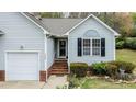 Inviting front entrance with red brick steps, light-gray siding, and well-maintained landscaping at 1808 W Cotton Gin Dr, Clayton, NC 27527