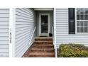 Charming front porch with brick steps, screen door, and light-gray siding on this lovely home at 1808 W Cotton Gin Dr, Clayton, NC 27527