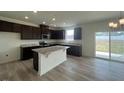 Modern kitchen featuring dark cabinets, stainless steel appliances, and an island at 190 Chestnut Oak Ln, Lillington, NC 27546