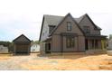 This new construction home features a detached garage, modern siding, and black framed windows at 20 Serenity Woods Trl, Franklinton, NC 27525