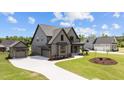 Attractive two-story home with gray siding, black trim, an attached garage, and well-kept landscaping at 20 Serenity Woods Trl, Franklinton, NC 27525