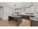 An elegant kitchen boasts a large island, modern light fixtures, and state-of-the-art appliances at 20 Serenity Woods Trl, Franklinton, NC 27525