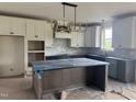 Spacious kitchen featuring custom cabinets, a large island, and a stylish backsplash at 20 Serenity Woods Trl, Franklinton, NC 27525