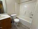 Bathroom with a shower-tub combo, toilet, vanity with wood cabinets and tiled floor at 202 Allen St # A/B, Creedmoor, NC 27522