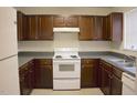 Functional kitchen boasts ample cabinet space, white appliances, and neutral countertops at 207 Mill St # A/B, Creedmoor, NC 27522