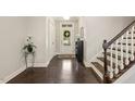 Elegant foyer with hardwood floors, staircase, and bright white trim offering a warm welcome at 207 Wildfell Trl, Cary, NC 27513