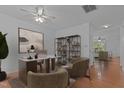 Well-lit home office space with a large desk, decorative shelves, and inviting decor at 2112 Queensway Ct, Creedmoor, NC 27522