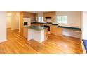 Spacious kitchen with hardwood floors, an island, and light wood cabinets at 212 Blueridge Rd, Carrboro, NC 27510