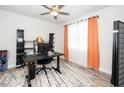 Cozy home office with a ceiling fan, a large window, and ample shelving at 235 Mallard Loop Dr, Clayton, NC 27527