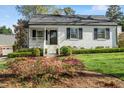 Charming home with a well-maintained lawn and garden featuring vibrant pink azaleas at 2714 Gordon St, Raleigh, NC 27608