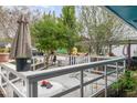 Backyard patio area featuring an umbrella, mature trees, and an exterior fence for added privacy at 2801 Bethune Dr, Raleigh, NC 27603
